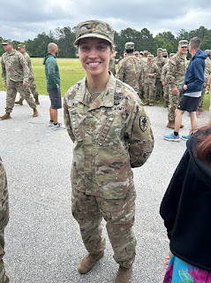 Army 2nd Lt. Olivia Agee stands with her arms behind her back in Army fatigues.