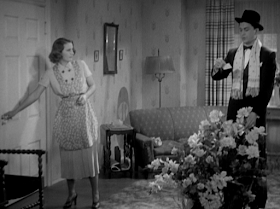 And Hugh (Robert Young) offers Carolyn (Barbara Stanwyck) huge fancy bouquets.