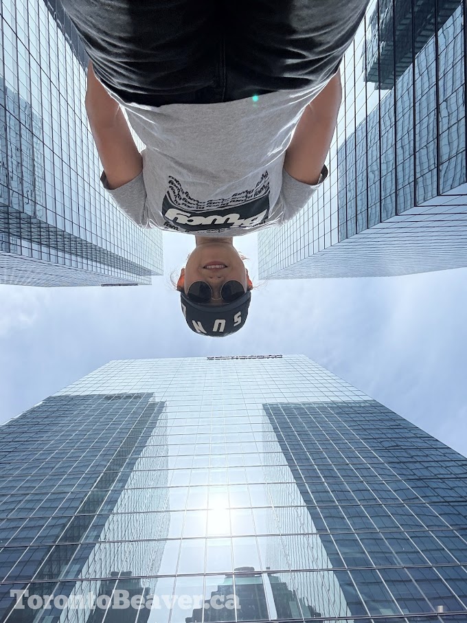 Looking Up From Ground Level To See A Human And Toronto Skyscrapers