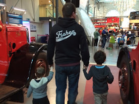Baby boy, Daddy and Big boy holding hands at the Transport Museum 