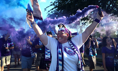 Orlando Pride supporters march to the stadium prior to Saturday’s maiden match