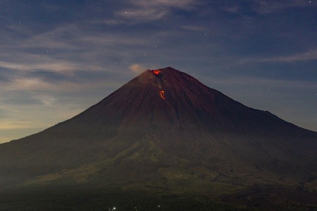 Incandescent lava coming out of the crater of Mount Semeru, seen from Simbar Semeru, Lumajang, East Java.