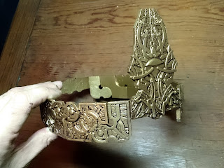 Showing the crown with a layer of brown paint applied and removed. 