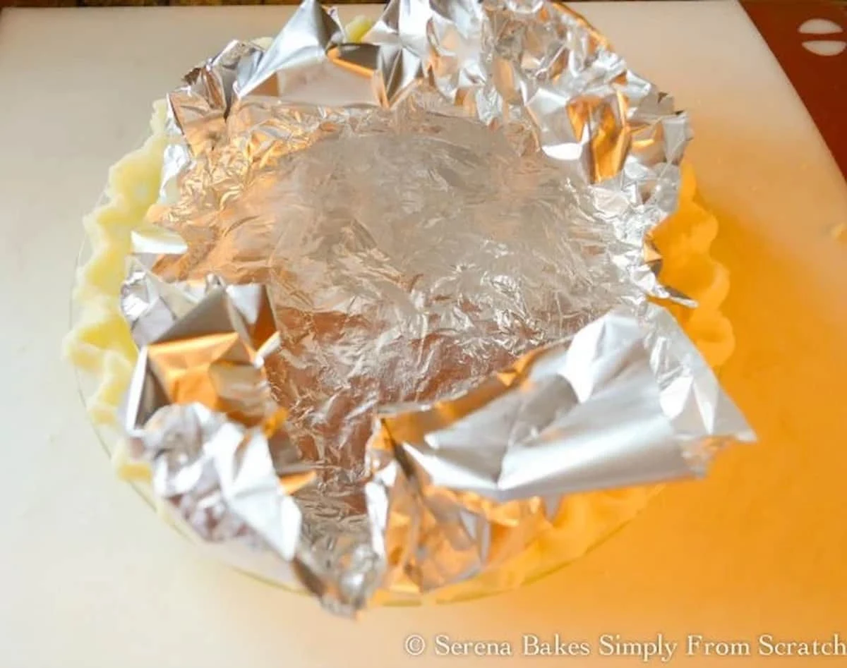 Dairy Free Gluten Free Pie Crust lines with tin foil to bake.