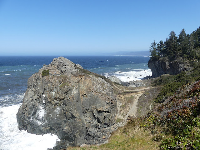 small rocky headland with a trail on the top