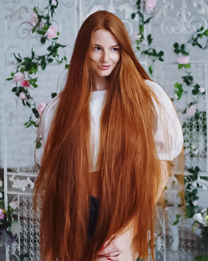 a portrait of a woman in the studio with long ginger hair