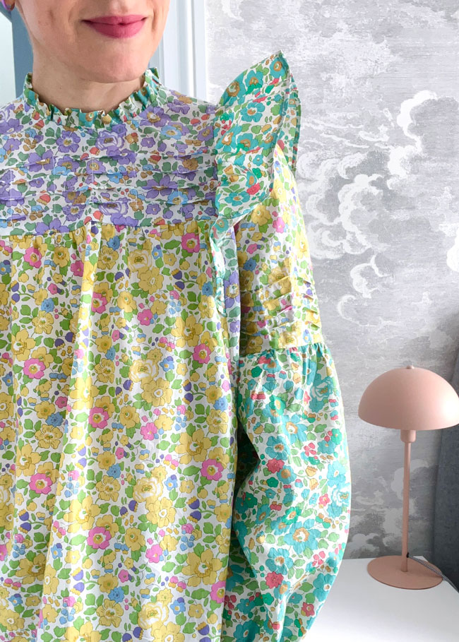 Close up shot of ruffled blouse made in Liberty floral printed cotton