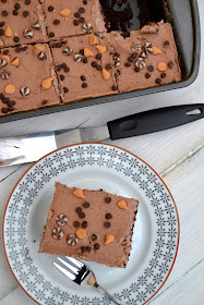 Chocolate sheet cake, poked and filled with butterscotch flavour pudding. Topped with a chocolate cream topping and chocolate chips.