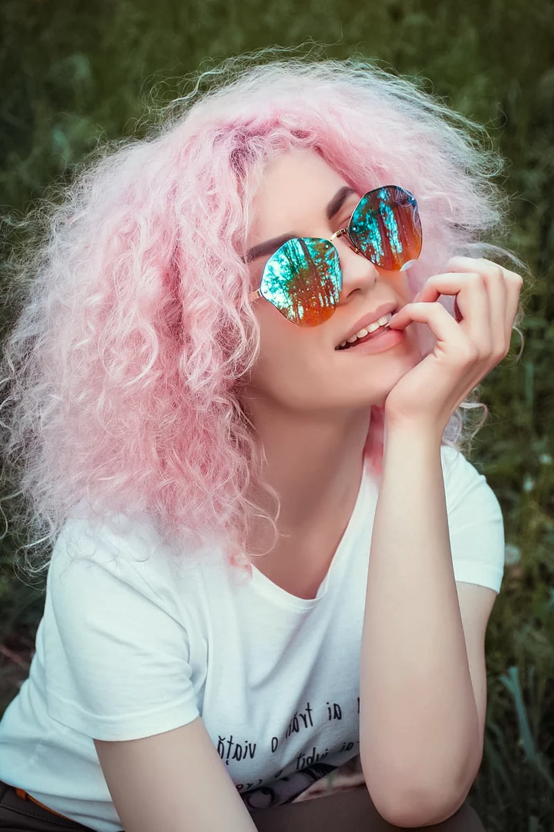 beautiful woman with curly pastel hair and wearing white t-shirt