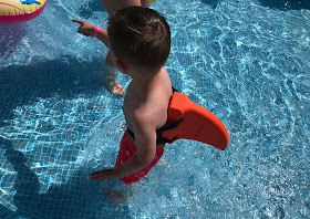 wearing a orange swimfin in the pool 