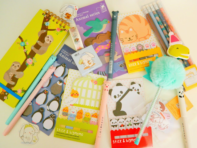 a photo showing various cute stationery items; pens, sticky notes, notebooks