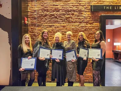 Group of JMC Employees Standing with Certificates at the December 2023 Dinner