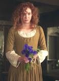 A Young Demelza holding bluebells in the Nampara parlour