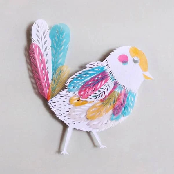 white papercut bird with pastel vellum accents