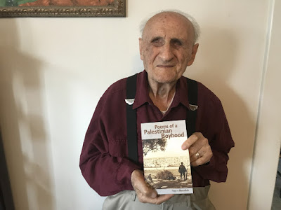 Reja-e Busailah with his latest publication Poems of a Palestinian Boyhood.