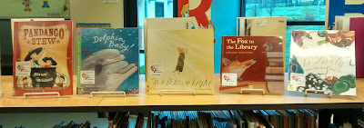 Patricia Gallagher Book Award nominated titles, arranged on library counter-top