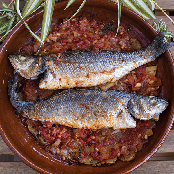 Lubina al horno con sofrito de tomate y piñones