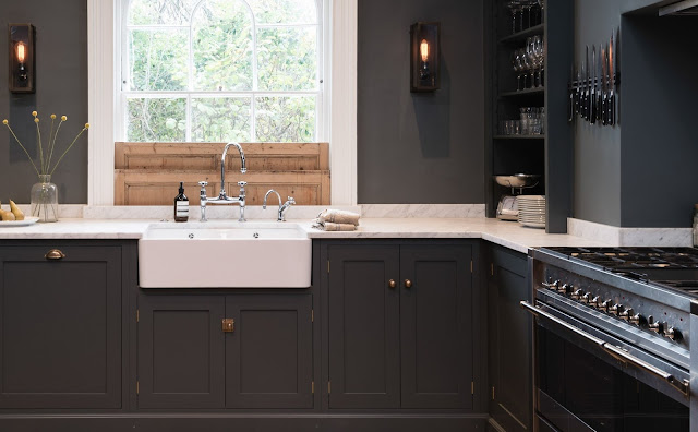 Dark blue-grey cabinets and walls in a luxurious classic London kitchen - found on Hello Lovely Studio