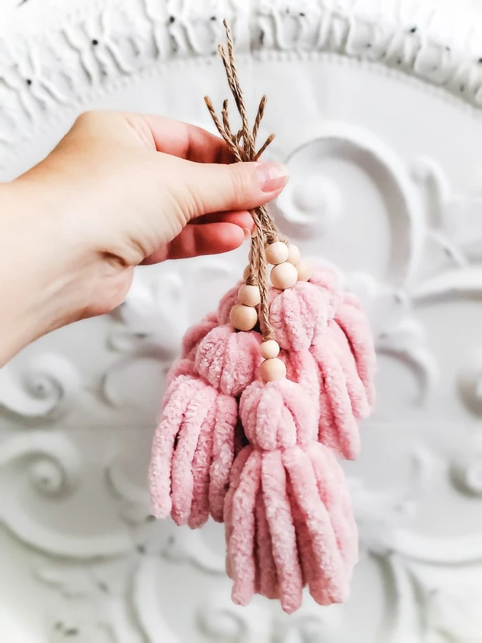 wood bead and pink yarn tassels