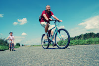 Man and child riding bicycles