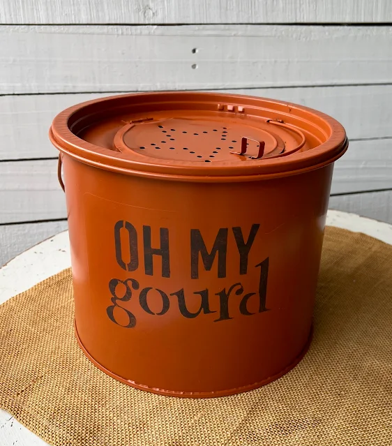 Photo of a spray painted orange minnow bucket with fall stencil.