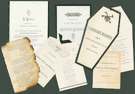 A photograph showing several papers regarding funereal proceedings for mathematics. Some are shaped as coffins or include illustrations of bats and bones.