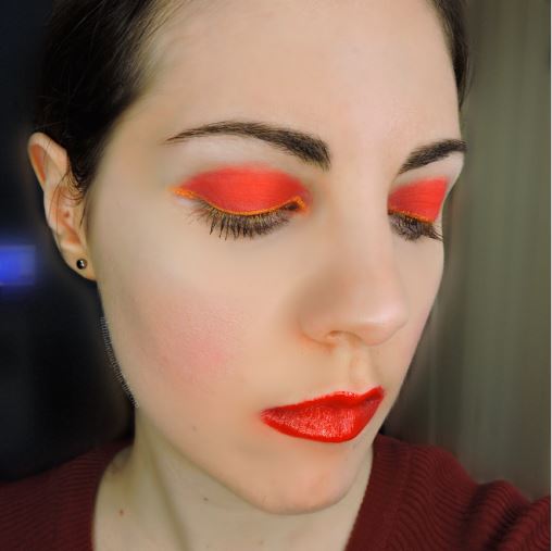 Ultima Beauty, eyes closed, Wearing Kansas City Chiefs inspired makeup colors