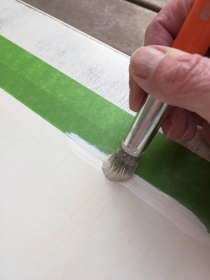 Apply a thin coat of paint to prevent it from seeping under the tape.