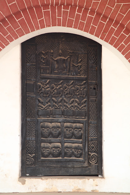 a carved wooden door of the old palace