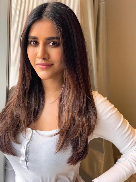 Nabha Natesh looks adorable in a cute pose, dressed in a white outfit