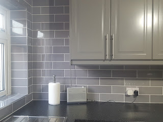 Grey Kitchen Tiles and Cabinets with Black Flecked Worktops