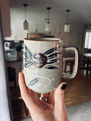 Image of a hand holding a coffee mug