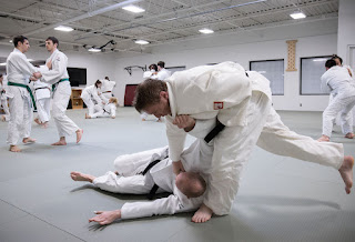 a man being thrown to the ground during judo in Ann Arbor