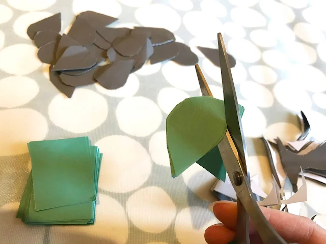 Close up of cutting a raindrop shape out of coloured paper