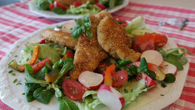 Breaded Chicken Strips On Top of a Lettuce Salad
