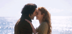 Ross and Demelza Poldark kissing on a beach season 2