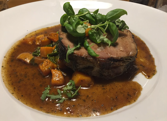 Slow-braised lamb shoulder with minted spinach, butternut squash & rosemary jus. 