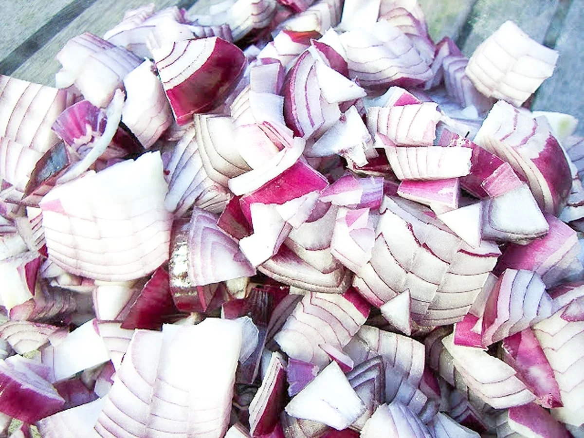 Chopped red onions in a large pan.