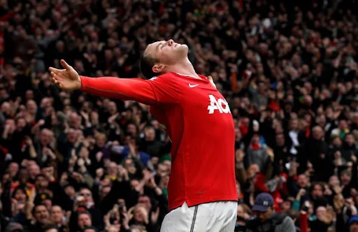 Manchester United forward Wayne Rooney celebrates after scoring the winning goal against Manchester City
