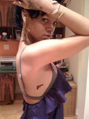 So Rihanna experimented at first, and had the tattoo artist draw two guns on
