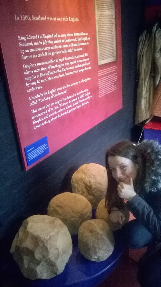 Photo: Barbara's daughter examining the missiles which collided with Castle Caerlaverock during the real life siege battle.