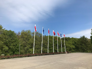 flags on tall poles underneath a blue sky