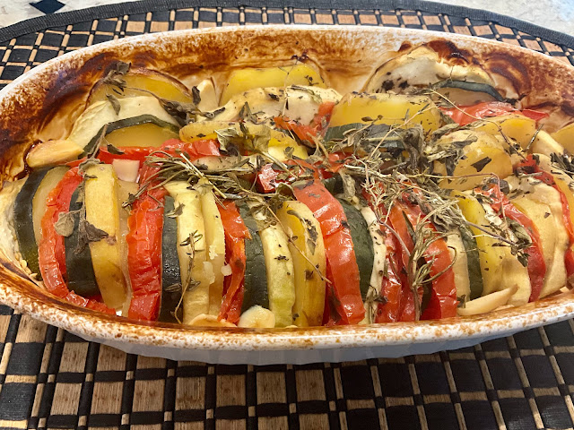 casserole with cooked tomatoes, zucchini, and eggplant layered