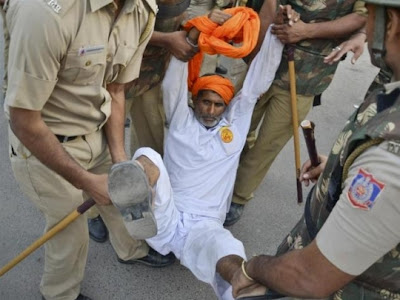 police carrying a old man forcefully out of protest arena