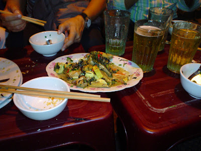 Eating snake with tofu in a street restaurant of Hanoi (Vietnam)