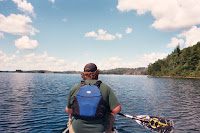 A man in a canoe on a lake