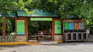 Entrance to Parque Nacional Los Tres Ojos Entrance to Parque Nacional Los Tres Ojos; a wooden gate with recycling cans on the right