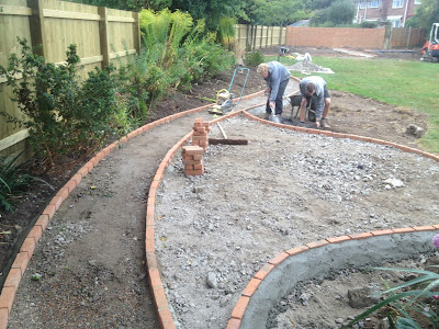 Pathway and patio edging being installed