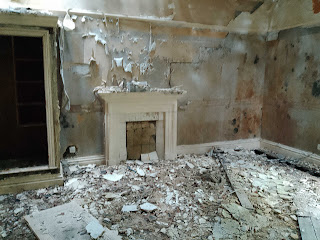 <img src="img_18th century mansion in Todmorden.jpg" alt="Image of 1930s tile fireplace in a room">