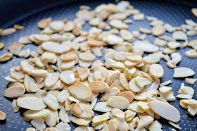 Flaked almonds toasting in a pan